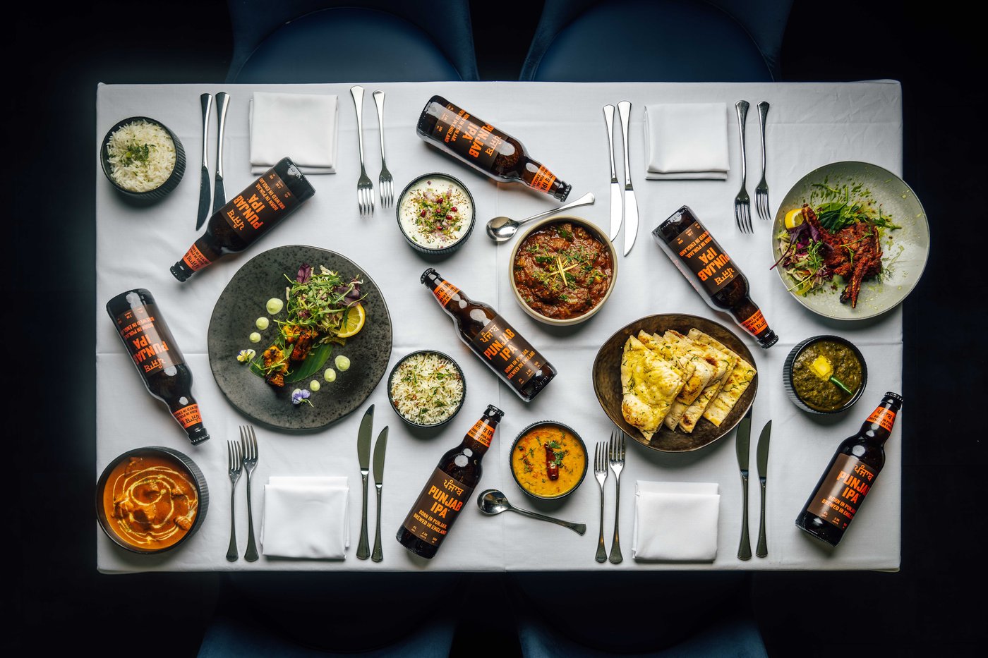Punjab IPA spread across a full table of Indian dishes